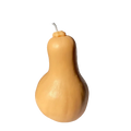 Realistic butternut squash shaped candle in natural tan and cream tones