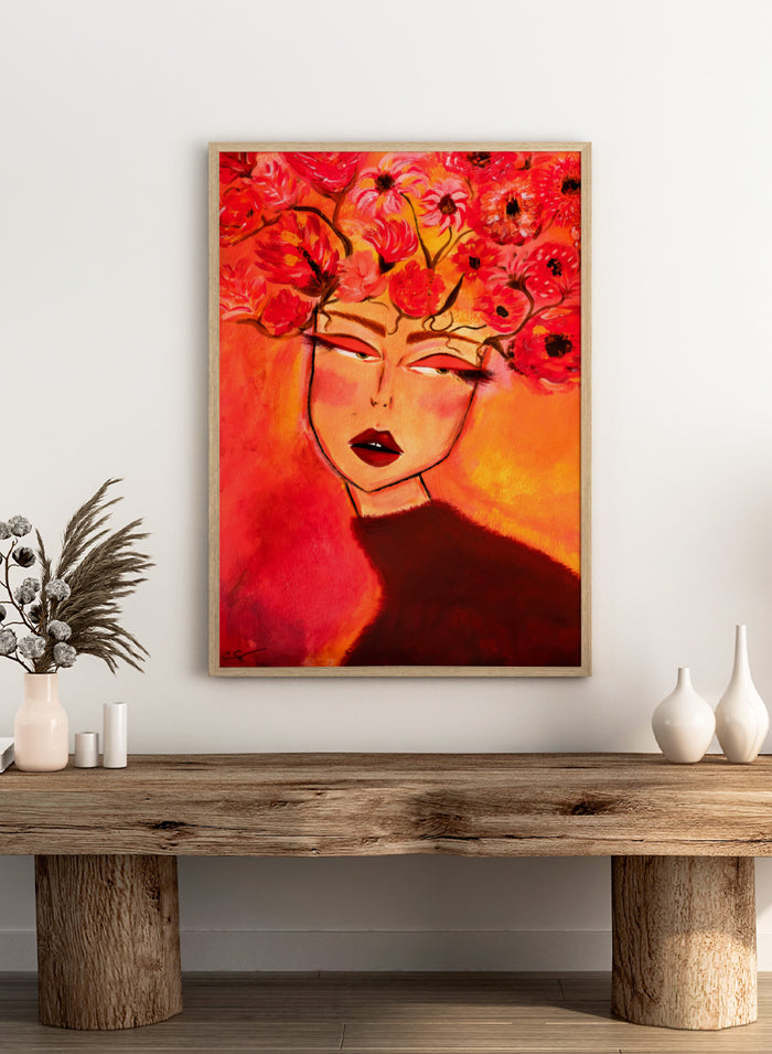A vibrant portrait painting of a woman with closed eyes, surrounded by a large crown of red and pink flowers, set against a warm orange and red background. Shop Woman with Floral Head by Amy Straley, a contemporary figurative wall art print featuring a woman portrait, floral crown, and vivid red, pink, and orange tones.