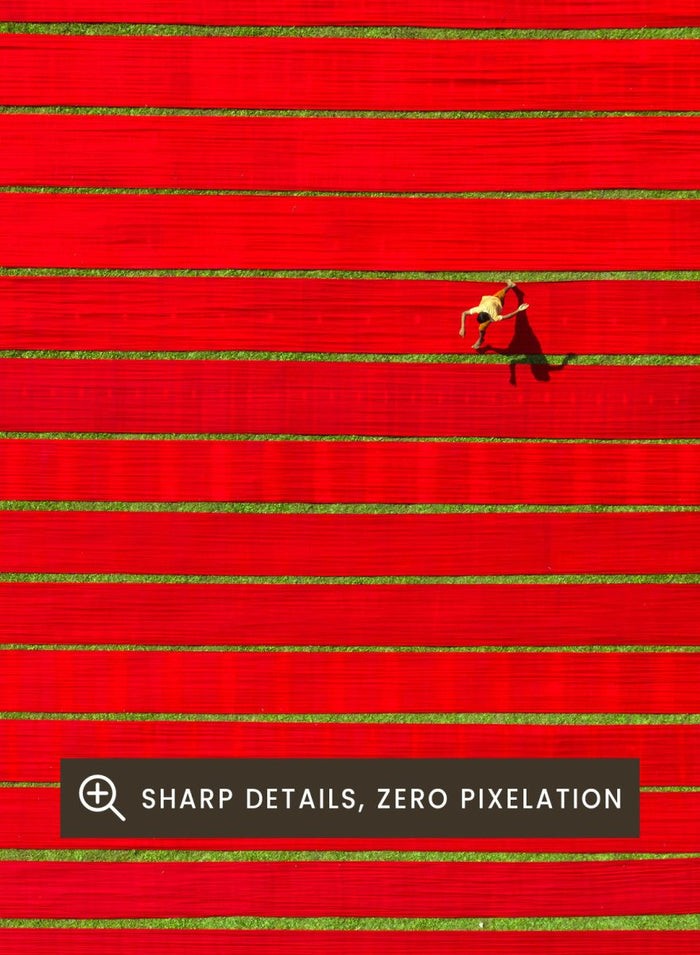Drying Colorful Cloth by Azim Khan Ronnie aerial photography print showing red textile fabric drying in Bangladesh fields, cultural wall art poster