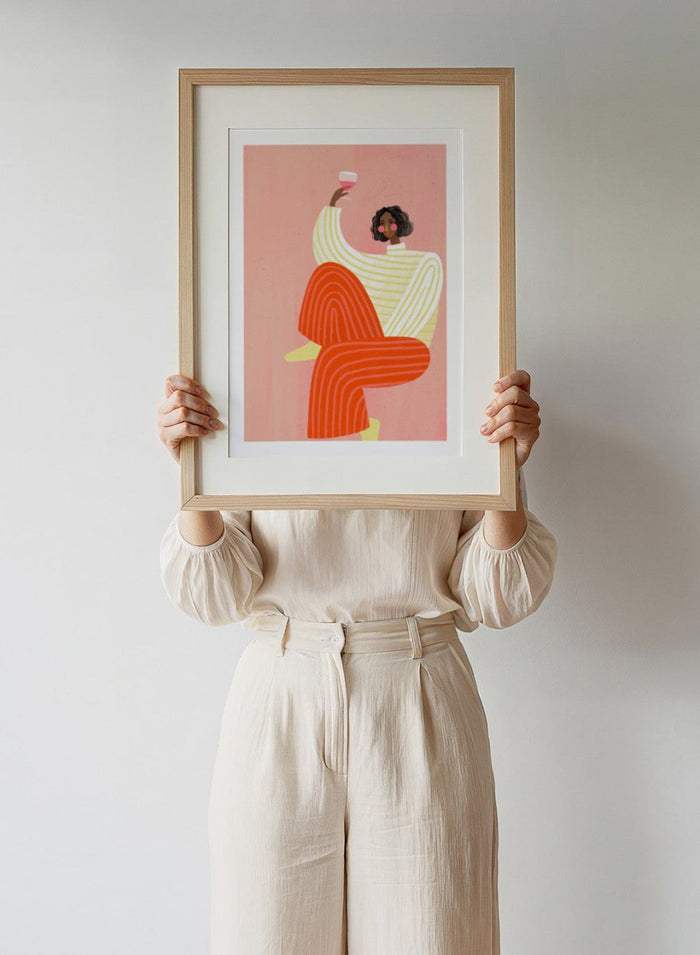 The Woman With a Glass of Wine by Bea Müller is an officially licensed art print featuring bold color and a modern illustrated portrait. Available framed or unframed.