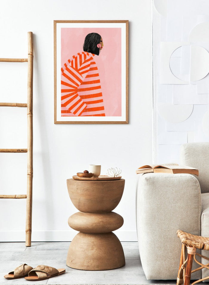The Woman With the Orange Stripes by Bea Müller is an officially licensed art print featuring bold orange stripes and a modern illustrated woman. Available framed or unframed.