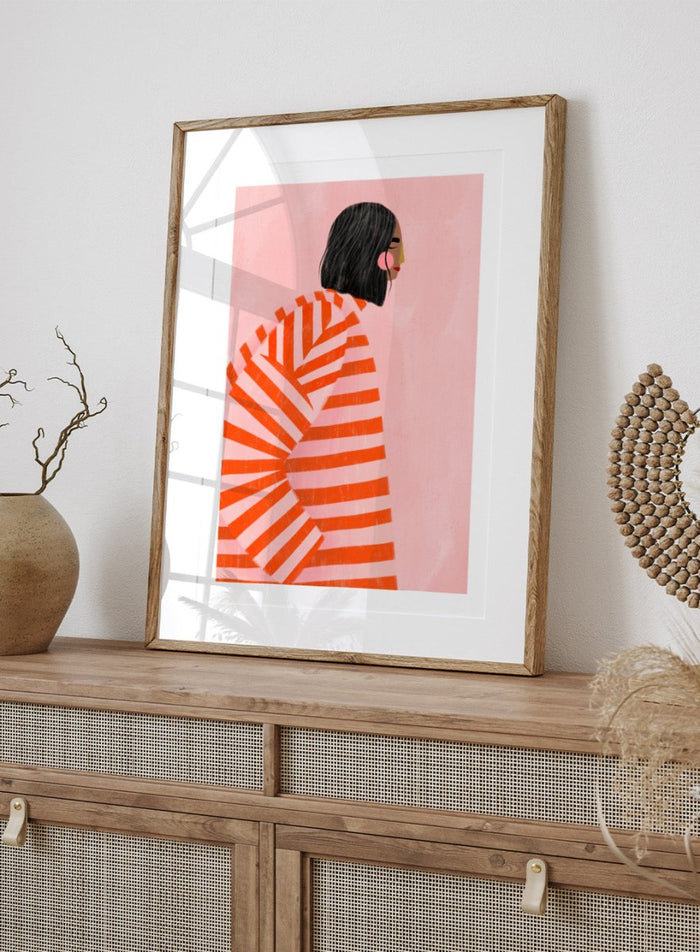 The Woman With the Orange Stripes by Bea Müller is an officially licensed art print featuring bold orange stripes and a modern illustrated woman. Available framed or unframed.