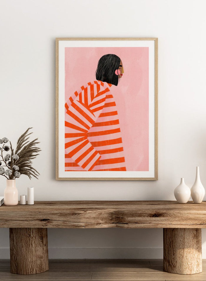 The Woman With the Orange Stripes by Bea Müller is an officially licensed art print featuring bold orange stripes and a modern illustrated woman. Available framed or unframed.