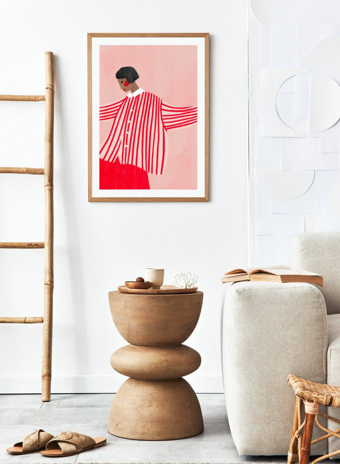 The Woman With the Red Stripes by Bea Müller is an officially licensed art print featuring bold red patterns and a modern illustrated woman. Available framed or unframed.
