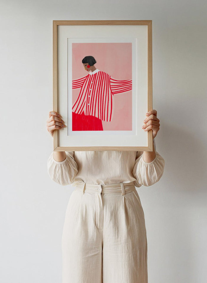 The Woman With the Red Stripes by Bea Müller is an officially licensed art print featuring bold red patterns and a modern illustrated woman. Available framed or unframed.
