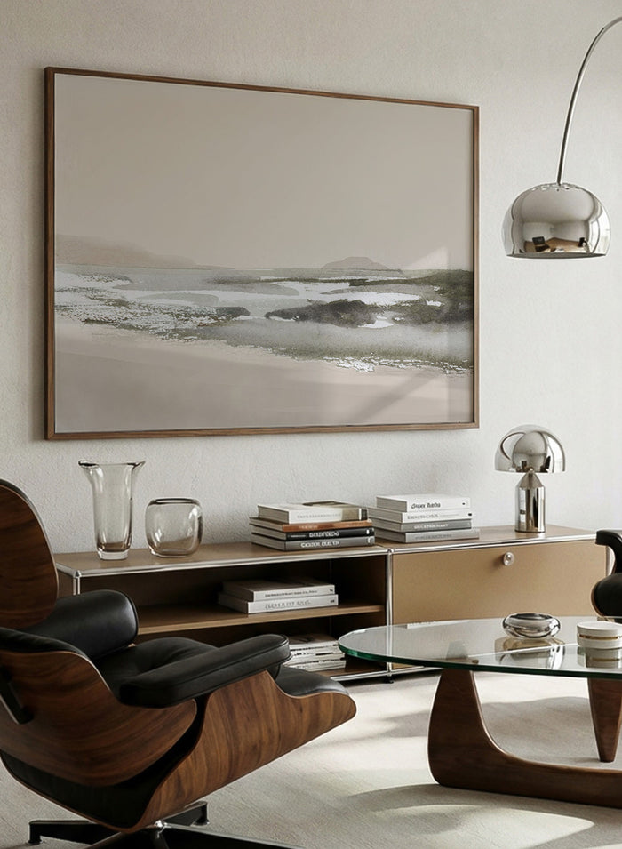 A framed landscape art print featuring a minimalist beach scene in muted beige, gray, and white tones. hop Calm Beach by Dan Hobday, a contemporary coastal wall art print featuring a soft shoreline, calm water, muted beige and gray tones, and textured detail.