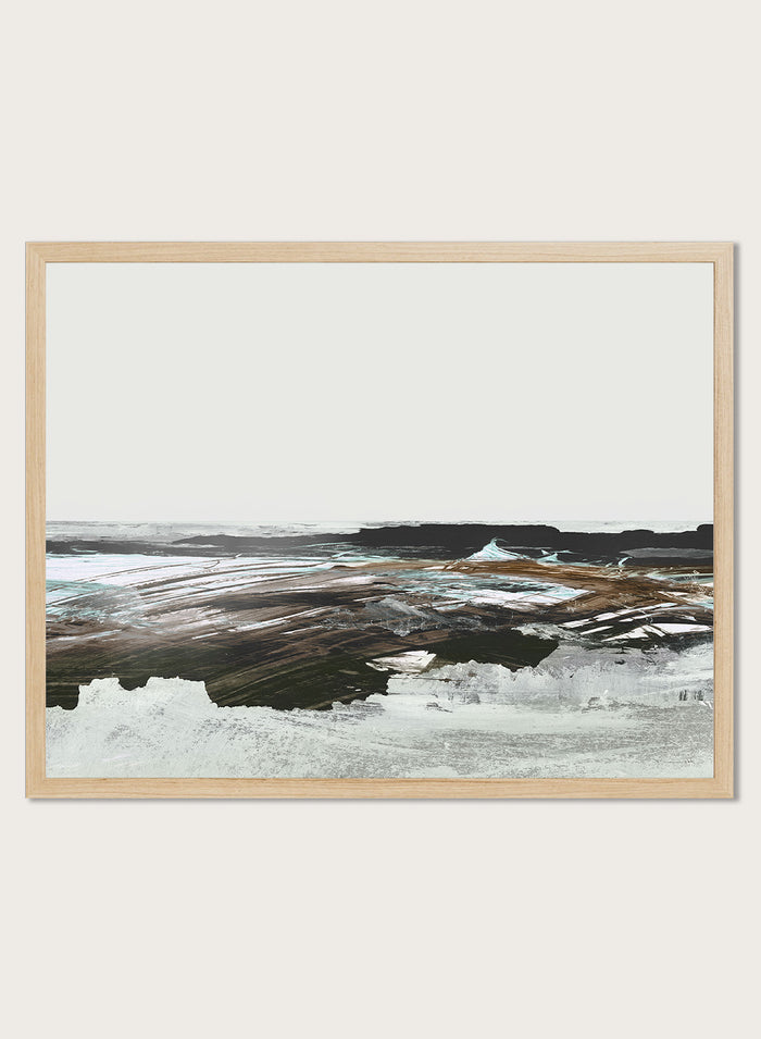 A framed abstract landscape art print featuring textured brushstrokes of brown, white, gray, and black. Shop Constantine Bay by Dan Hobday, a contemporary coastal wall art print with abstract shoreline forms, pale blue accents, dark brown tones, and textured brushwork.