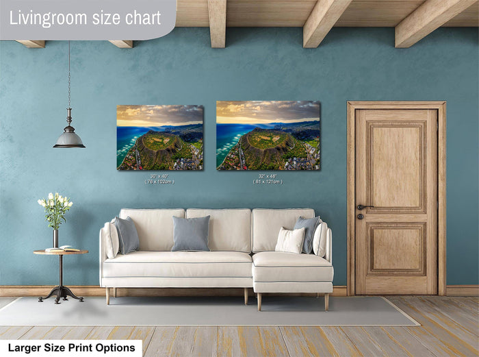 a living room with a white sofa, a wooden door, and two framed landscape paintings hanging on the wall.