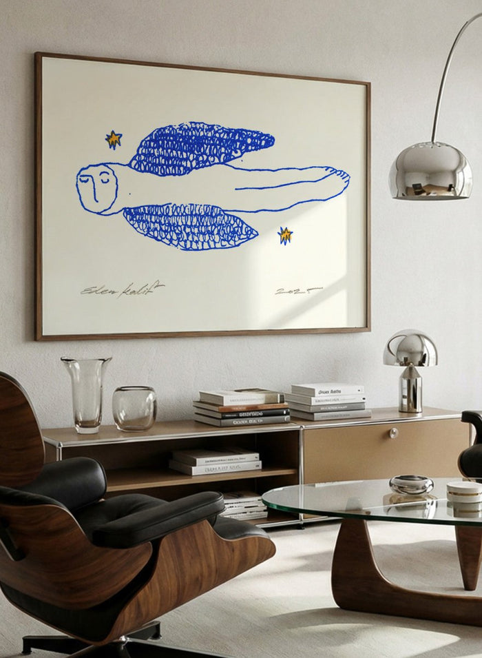 Framed artwork of a blue abstract figure with stars on a white background. Angel by Eden Kalif is a modern line art print of a winged figure with blue detail, a contemporary minimalist wall poster with expressive drawing and subtle texture.