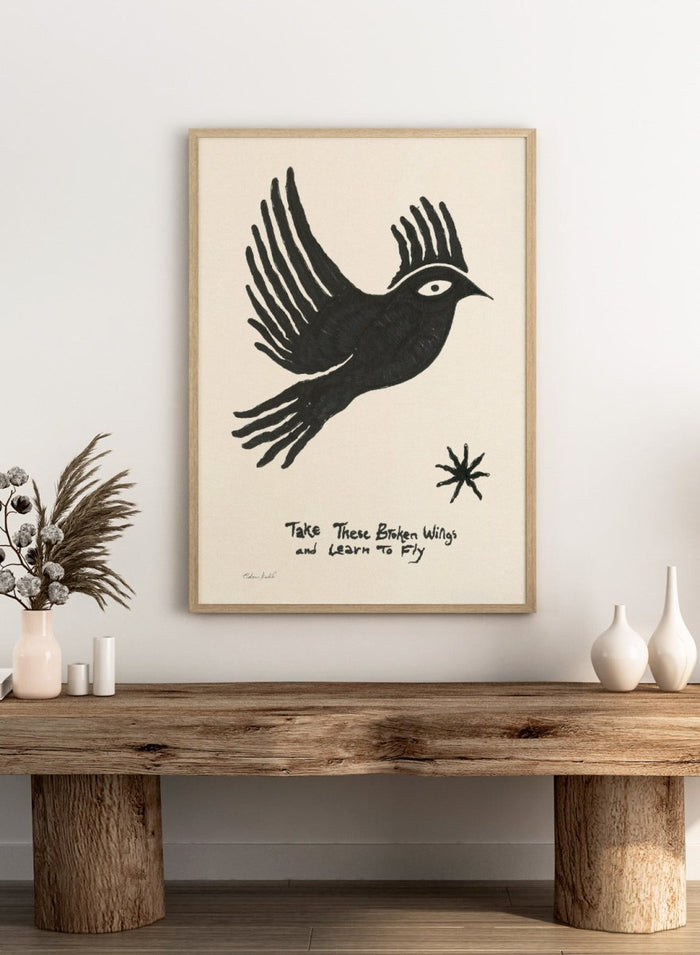 Black bird illustration with 'Take These Broken Wings and Learn to Fly' text on a beige background. Fly Away by Eden Kalif is a modern bird art print with expressive line work and handwritten text, a contemporary minimalist wall poster about growth and freedom.
