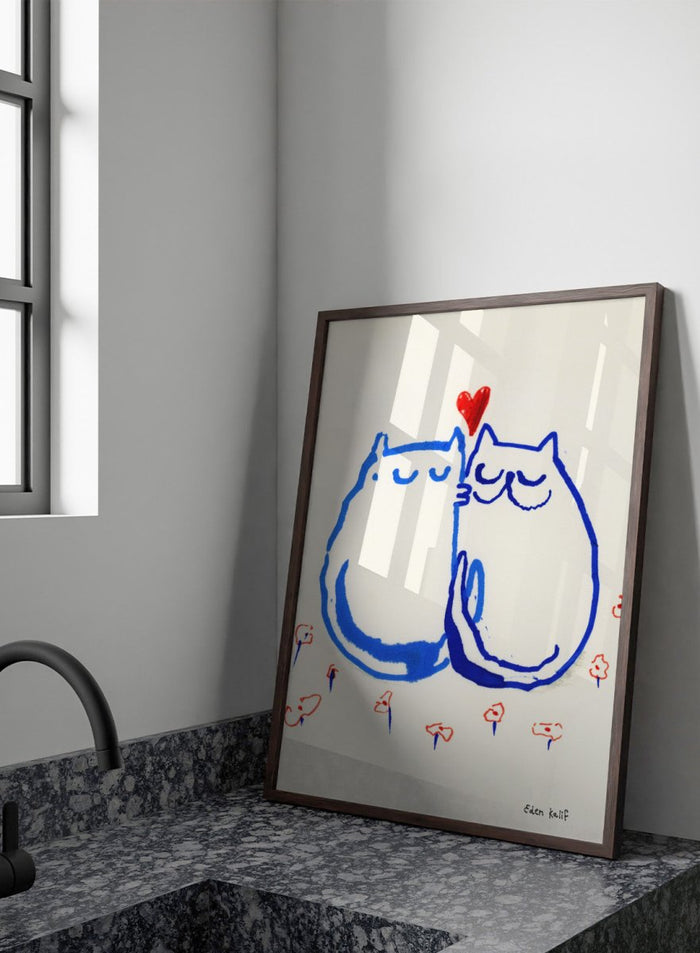 Two blue cats holding a red heart with small colorful flowers around on a white background. Lovin’ Cats by Eden Kalif is a modern cat art print with two figures and a red heart, a contemporary minimalist wall poster with playful form and expressive line work.