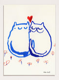 Two blue cats holding a red heart with small colorful flowers around on a white background. Lovin’ Cats by Eden Kalif is a modern cat art print with two figures and a red heart, a contemporary minimalist wall poster with playful form and expressive line work.