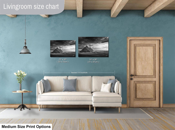 a living room with a white sofa, a wooden door, and a painting of a desert landscape above the sofa. The living room has a blue wall and a wooden floor.