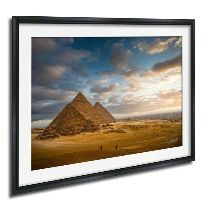 the iconic pyramids of Giza in Egypt, with a dramatic sky and clouds in the background.