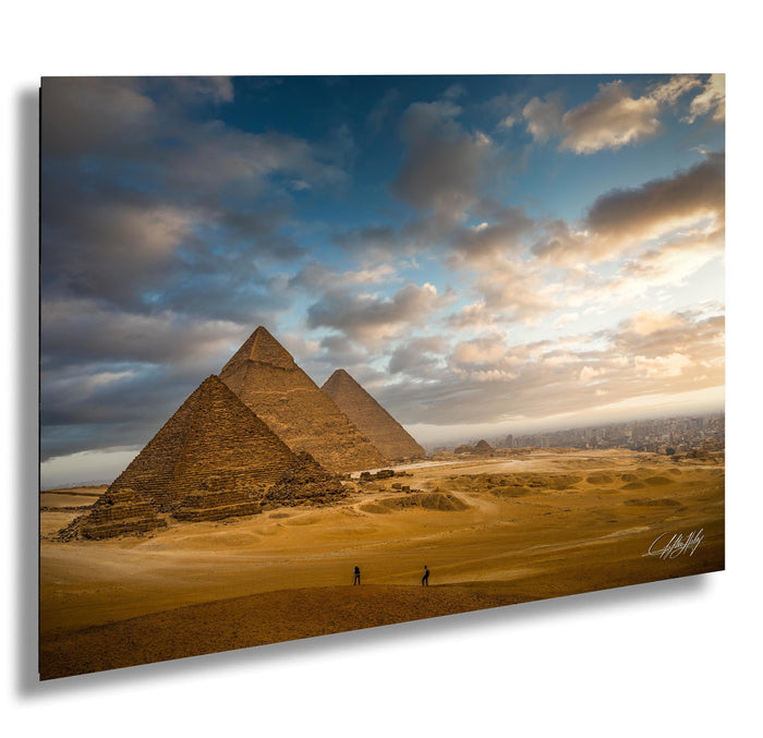the iconic pyramids of Giza in Egypt, with a dramatic sky and clouds in the background.