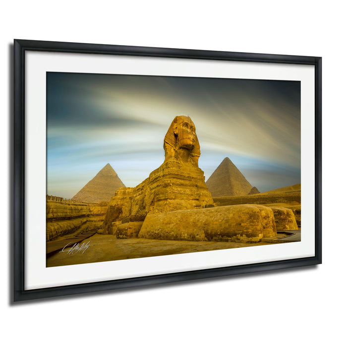 the Great Sphinx of Giza, a large limestone statue of a mythical creature, standing in front of the iconic pyramids of Giza in Egypt.