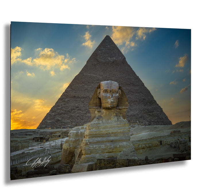 the Great Pyramid of Giza and the Sphinx, with a warm sunset sky in the background.