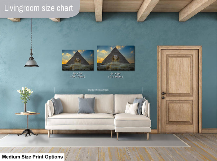 a living room with a white sofa, a wooden door, and a painting of the Great Pyramid of Giza on the wall.