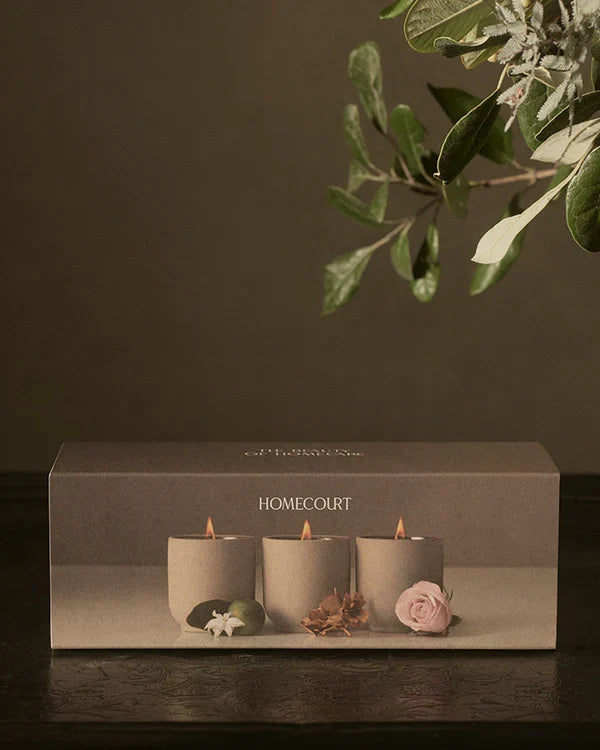 Three Homecourt hand-poured soy votive candles arranged for a gift discovery set
