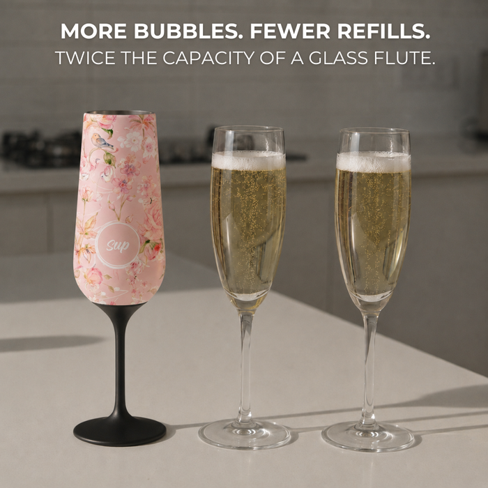 Two champagne flutes with one insulated flute with a pink floral design, on a neutral background.