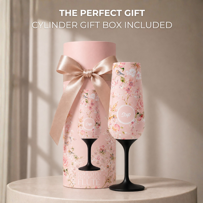Floral-patterned insulated champagne flute and with a matching cylindrical gift box on a neutral background.