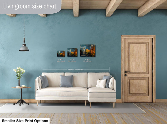 a living room with a white sofa, a wooden door, and a hanging light fixture. There are three framed artworks displayed on the wall, each with different sizes and dimensions. The living room appears to be well-decorated and spacious.