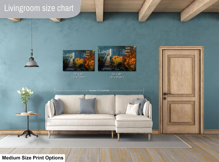 a living room with a white sofa, a wooden door, and a painting hanging on the wall. The painting is of a cityscape with a bridge and trees. The living room appears to be well-lit and decorated with a vase of flowers on a table.