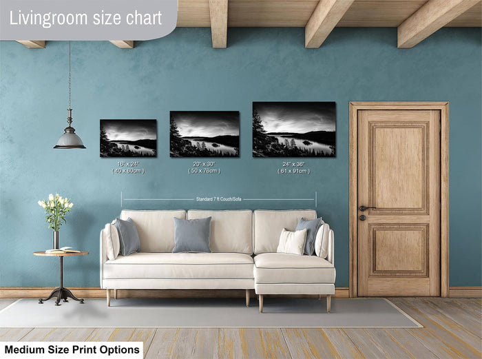 a living room with a white sofa and a wooden door. Above the sofa, there is a livingroom size chart that provides the dimensions of three framed landscape photographs in inches.