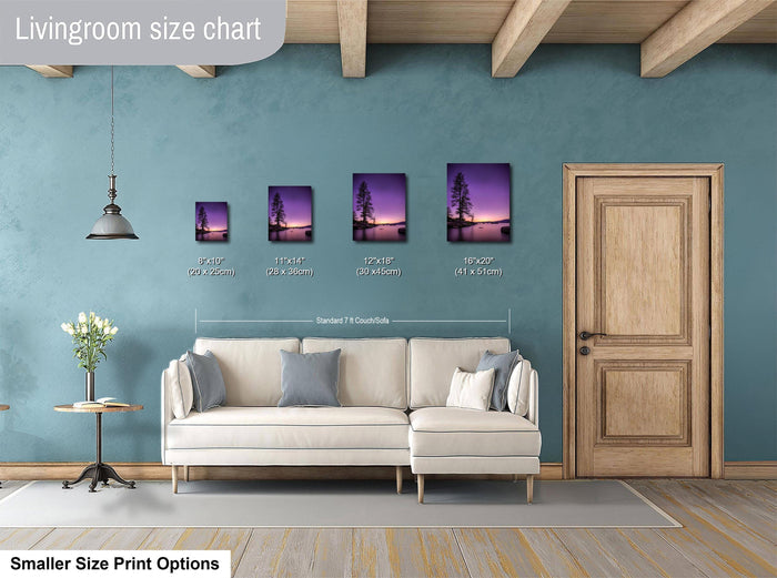 a living room with a white sofa and a wooden door. Above the sofa, there is a size chart displaying the dimensions of various framed artworks, including a sunset landscape.