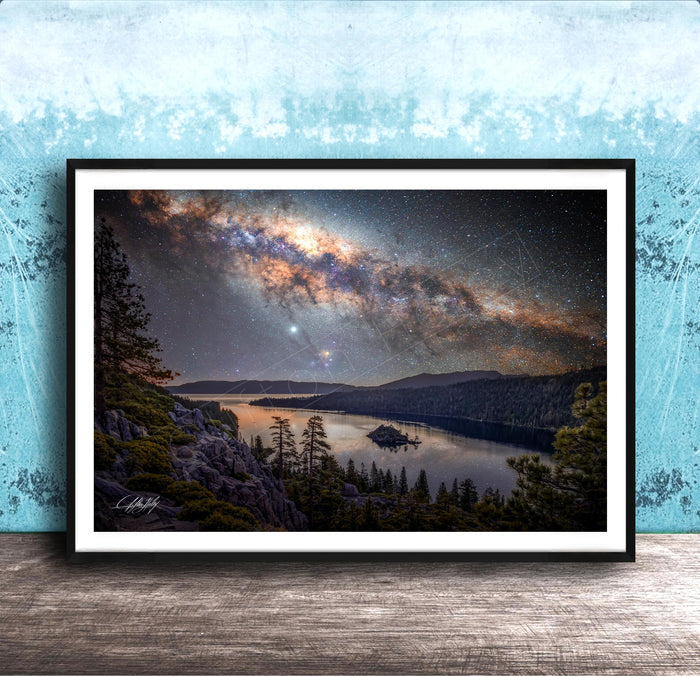 The image is a framed photograph depicting a serene night scene with a lake, mountains, and a starry sky.