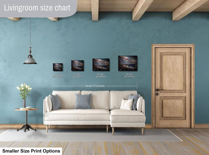 a living room with a white sofa, a wooden door, and a hanging light fixture. There are three framed landscape paintings displayed on the wall, each with a different size and frame. The living room appears to be designed for a smaller, more intimate space.