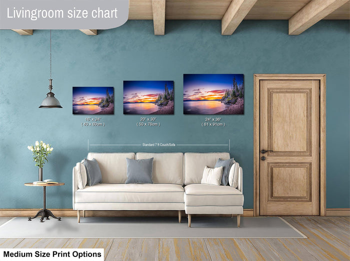 a living room with a white sofa and a wooden door. Above the sofa, there is a livingroom size chart that provides the dimensions of three different paintings. The chart indicates that the paintings are medium-sized, with a total width of 24 inches.