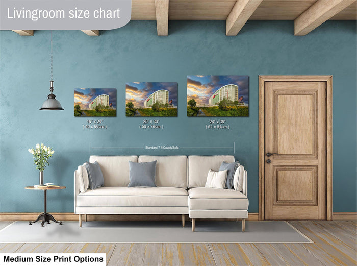 The image is a livingroom size chart with three framed prints of a building, likely a hotel, displayed on the wall. The prints vary in size, ranging from 10x14 inches to 24x36 inches. The livingroom itself includes a white sofa and a wooden door, creating a cozy and inviting atmosphere.