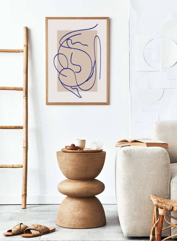 Abstract blue line art on a beige background. Abstract Fluid Line by Little Dean minimalist line art print featuring abstract female figure drawing, modern continuous line illustration wall art poster.