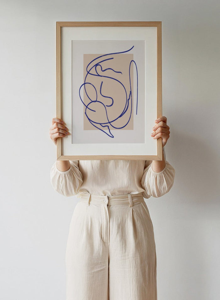 Abstract blue line art on a beige background. Abstract Fluid Line by Little Dean minimalist line art print featuring abstract female figure drawing, modern continuous line illustration wall art poster.