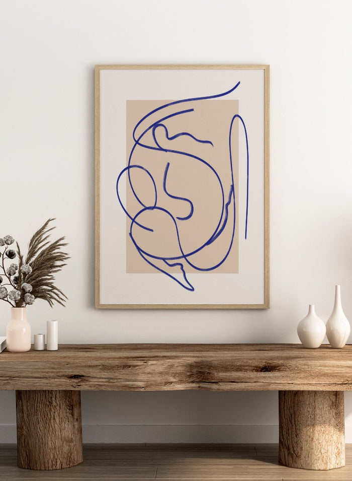 Abstract blue line art on a beige background. Abstract Fluid Line by Little Dean minimalist line art print featuring abstract female figure drawing, modern continuous line illustration wall art poster.