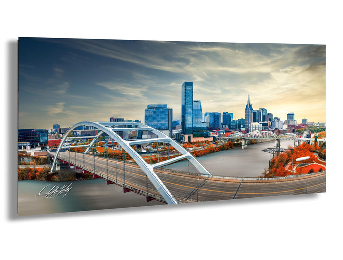 Nashville skyline sunset print, drone photo of Music City, Cumberland River wall art, Korean Veterans Bridge art, Tennessee skyline decor, autumn cityscape photography, Nashville downtown photo, sunset drone shot Nashville, iconic Batman Building art, golden hour cityscape, peaceful urban landscape, fine art Nashville print, inspirational city wall decor, modern Southern photography, skyline bridge photo