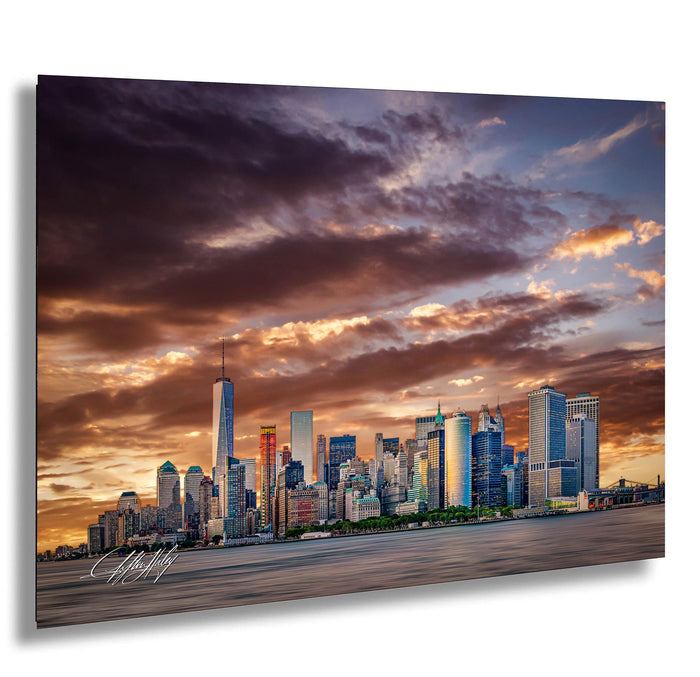 a city skyline at sunset, with the tall buildings silhouetted against a dramatic sky filled with clouds and warm hues.