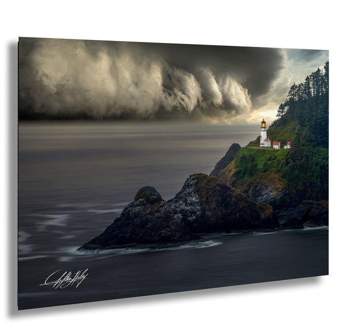 a lighthouse standing on a rocky cliff overlooking the ocean, with a stormy sky in the background.