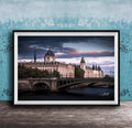 a picturesque scene of a historic building with a dome and a bridge spanning a river, set against a dramatic sky with clouds.