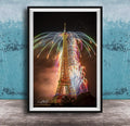 a tall, illuminated tower with a colorful display of fireworks in the sky, creating a vibrant and festive atmosphere.