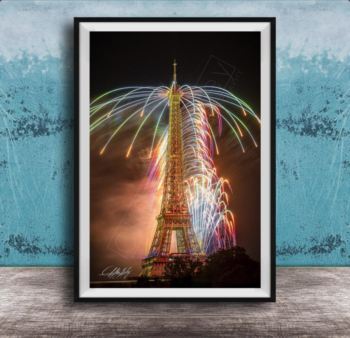 a tall, illuminated tower with a colorful display of fireworks in the sky, creating a vibrant and festive atmosphere.