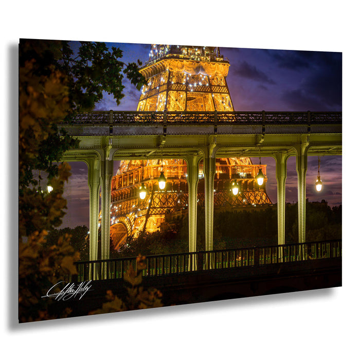 the Eiffel Tower at night, with its intricate iron lattice structure illuminated against a dark sky.