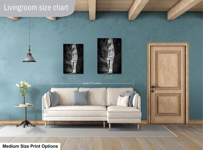 a living room with a white sofa, a wooden door, and a framed artwork hanging on the wall.