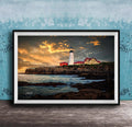 A framed photograph depicting a lighthouse on a rocky coastline at sunset, with the sky filled with clouds and the ocean in the background.