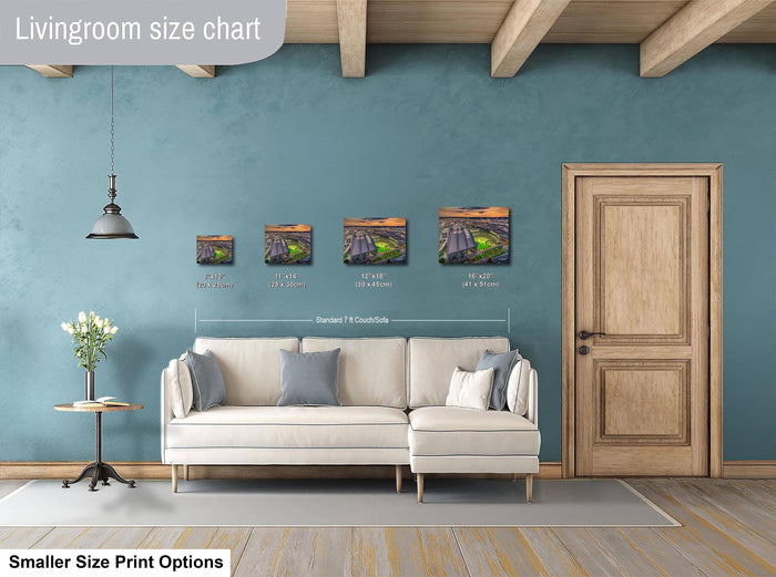 a living room with a white sofa, a wooden door, and a hanging light fixture. Above the sofa, there is a size chart displaying the dimensions of four framed artworks in inches.