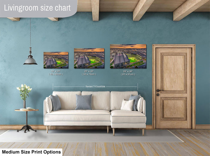 The image is a livingroom size chart with three framed prints of different sizes displayed on the wall. The prints are of a cityscape, and the wall is painted in a light blue color. There is a white couch in the living room, and a wooden door is visible on the right side of the image.