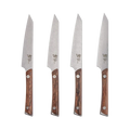 Set of four Shun Kanso steak knives with wooden handles arranged on a surface