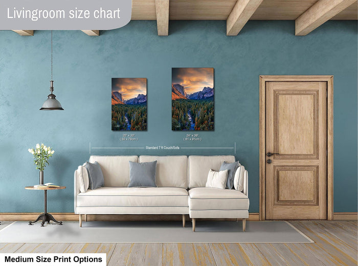 a living room with a white sofa, a wooden door, and two framed landscape paintings hanging on the wall.
