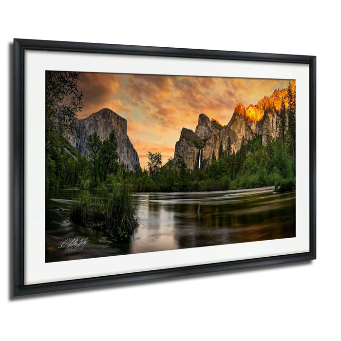 a serene landscape with a river flowing through a mountainous terrain, surrounded by lush greenery and towering cliffs. The sky is filled with vibrant colors, creating a stunning backdrop for the scene.
